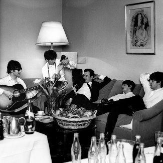 Brian Epstein and the band in hotel room